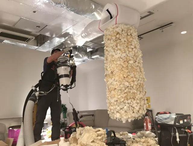 Barrington Air Duct Cleaning technician performing precision vacuum insulation removal in a residential property in Barrington